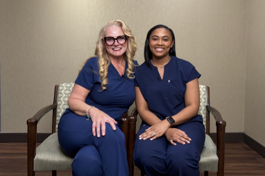 Nurses Ginger Rock and Xian Cooley sitting side by side